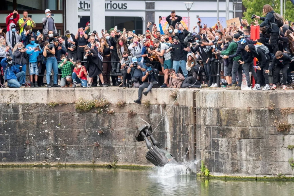 Manifestantes derrubam e lançam ao rio a estátua de Edward Colston, traficante de escravizados em Bristol, Inglaterra em 2020.