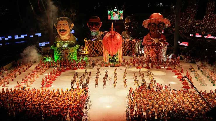 Transformar trauma em espetáculo é uma forma de resistência. No Festival de Parintins, a dor e a memória se tornam arte diante de 25 mil pessoas. Caprichoso e Garantido encenam histórias invisibilizadas pelo Brasil oficial, com cor, ritmo, ironia e orgulho.