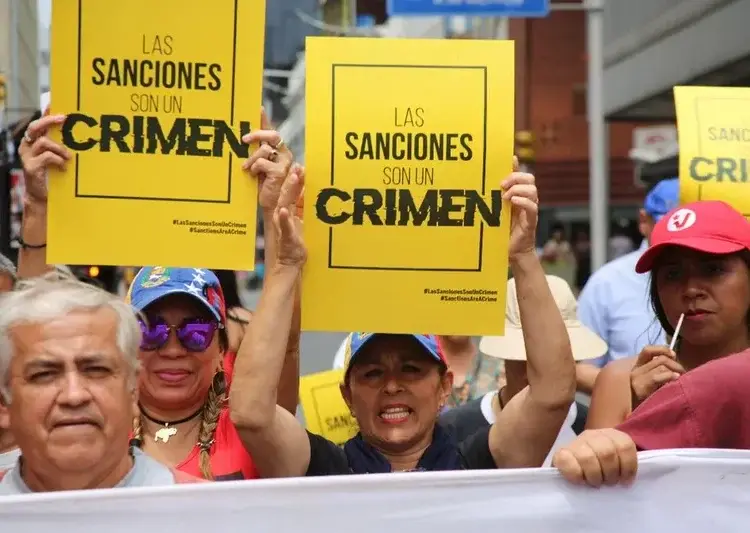 Protesto sancoes Venezuela As sanções impostas pelos EUA geram forte impacto político e social. Em Caracas, manifestantes protestam contra as medidas punitivas aplicadas à Venezuela, em ato convocado pelo Conselho Nacional de Direitos Humanos, órgão público ligado ao governo venezuelano. Imagem: Consejo Nacional de Derechos Humanos